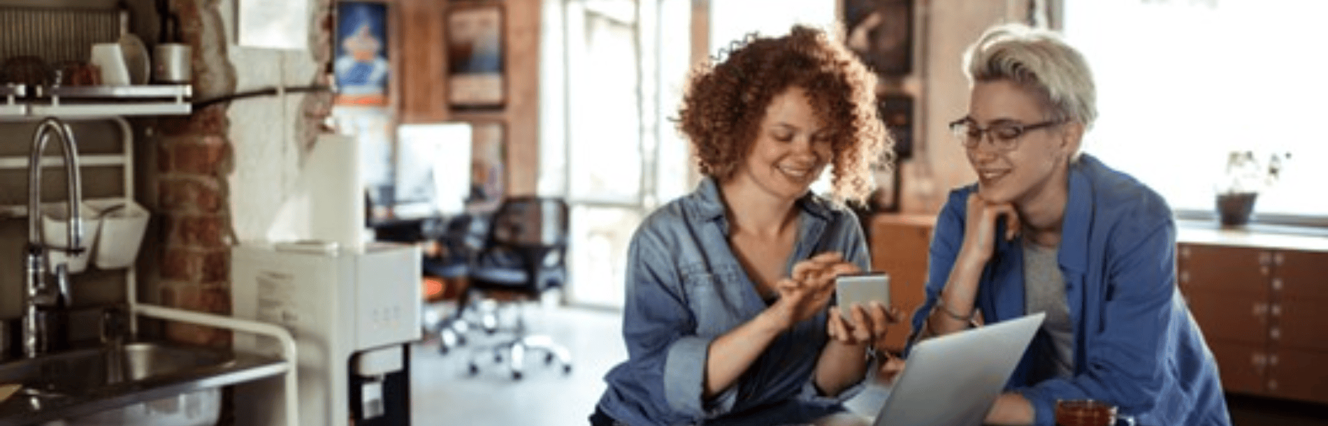 2 women collaborating using tablet computer